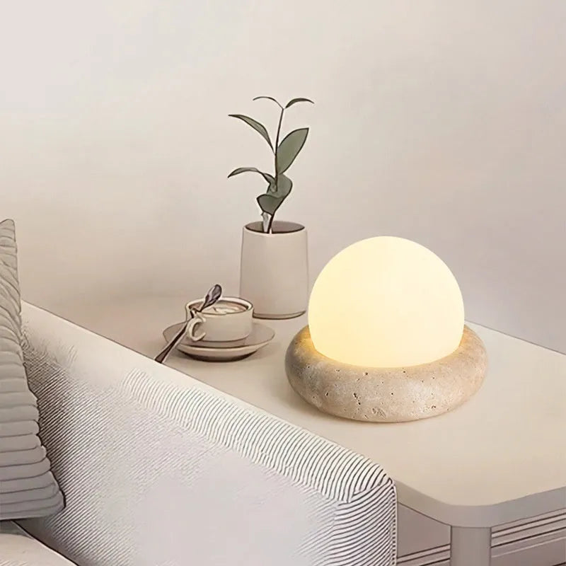 Cream modern bedside remote control night lamp with yellow cave stone light on bedside table