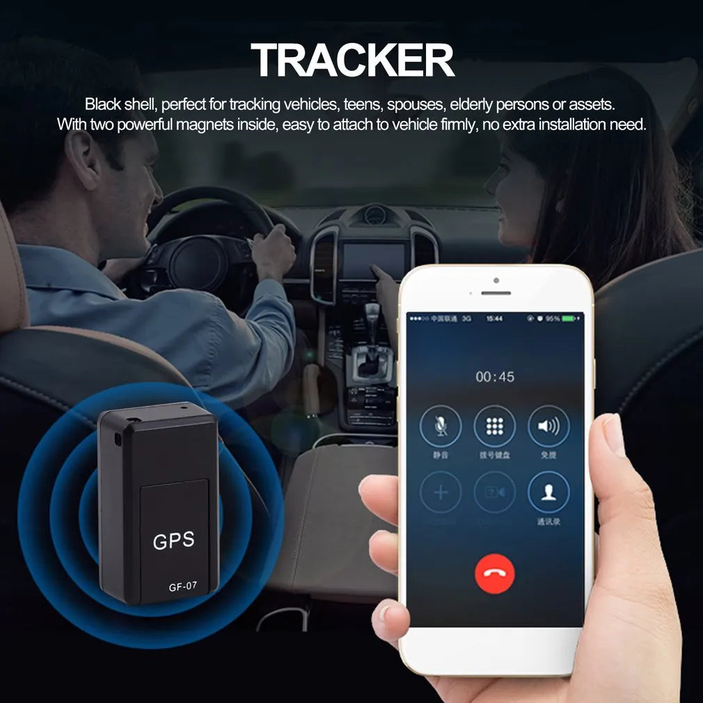 Small black plastic magnetic GPS car tracker device on a metal surface.