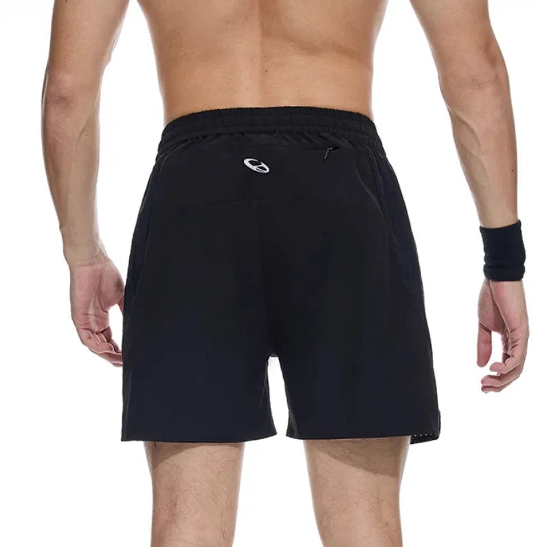 Men's black running shorts with laser stitching detail on a grey background
