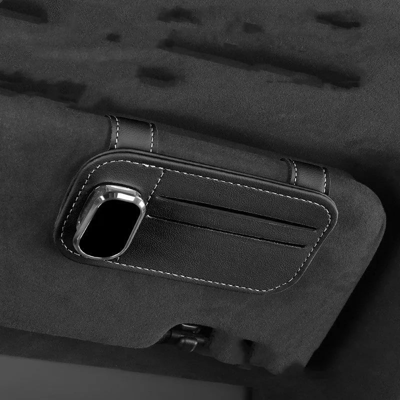 Beige leather car sun visor card holder with a glasses clip shown installed on a vehicle visor.
