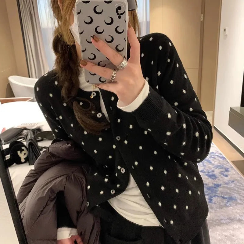 Women's grey dot pattern knitted cardigan with crocheted flower detail and long sleeves