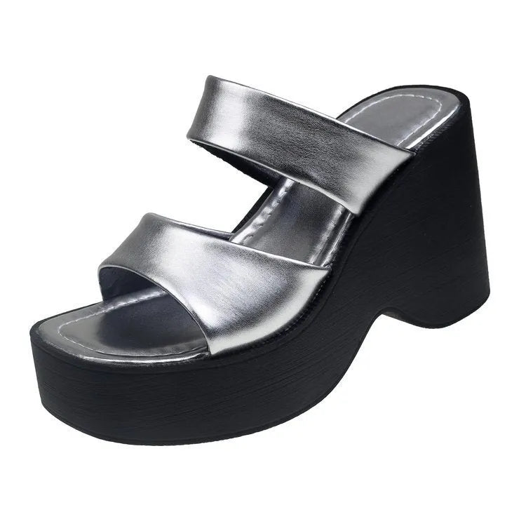 Women's black wedge platform slippers with a square toe on a white background.