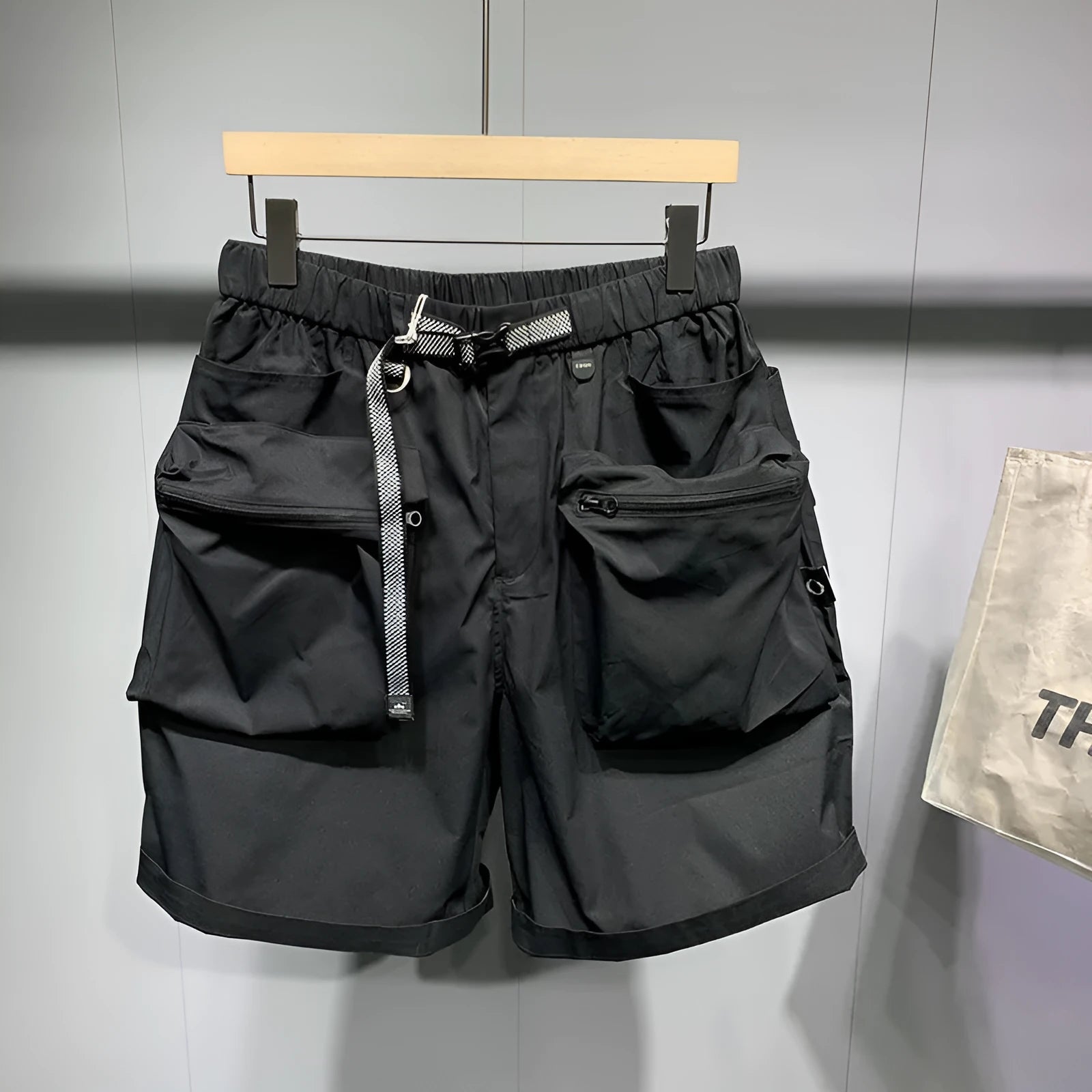 Men's black loose fitting workwear shorts with pockets, above-the-knee length with straight leg design