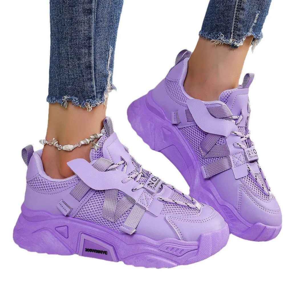 Women's purple platform mesh sports shoe with lace-up front and thick sole for height increase.