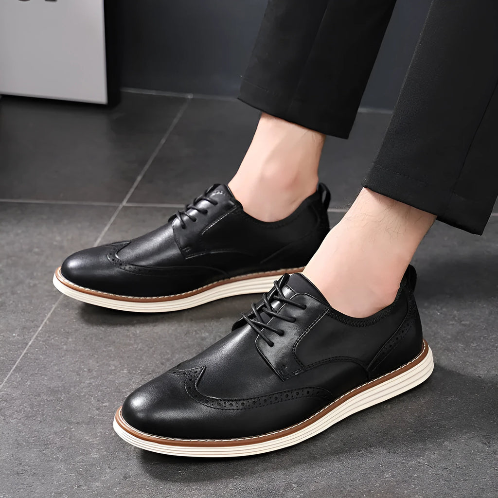 Men's black and brown slip-on business casual shoes with round toe and decorative carving detail