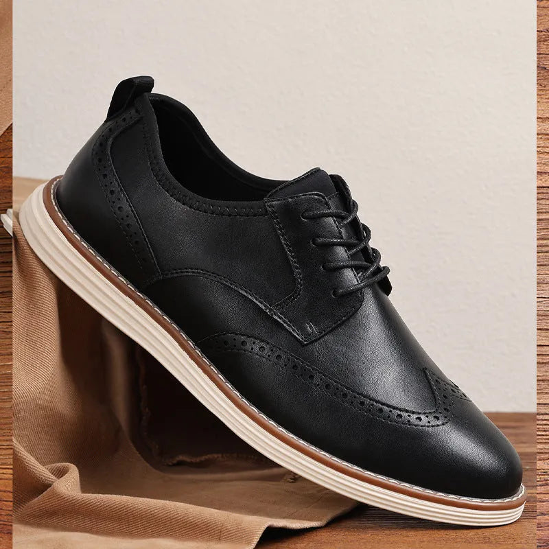 Men's black and brown slip-on business casual shoes with round toe and decorative carving detail