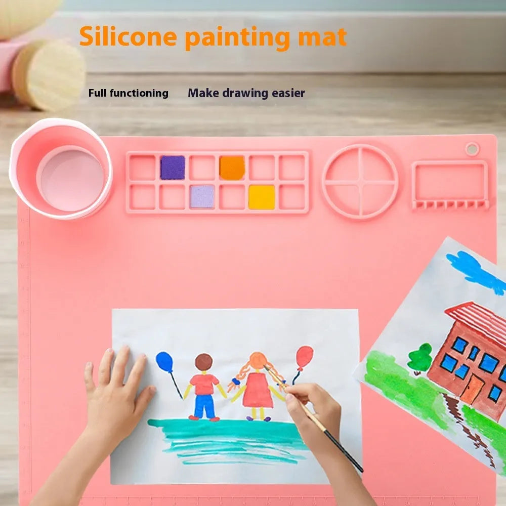 Light blue silicone painting mat with two round bowls on a 50cm by 40cm rectangular surface.
