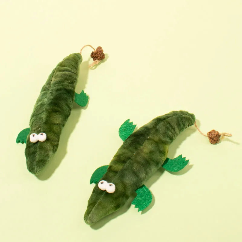 Green plush alligator cat toy with plant-based materials and peppermint scent for oral cleansing