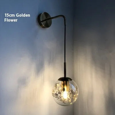 Modern glass wall lamp in golden flower or silver flower finish, shown in 15cm and 20cm sizes