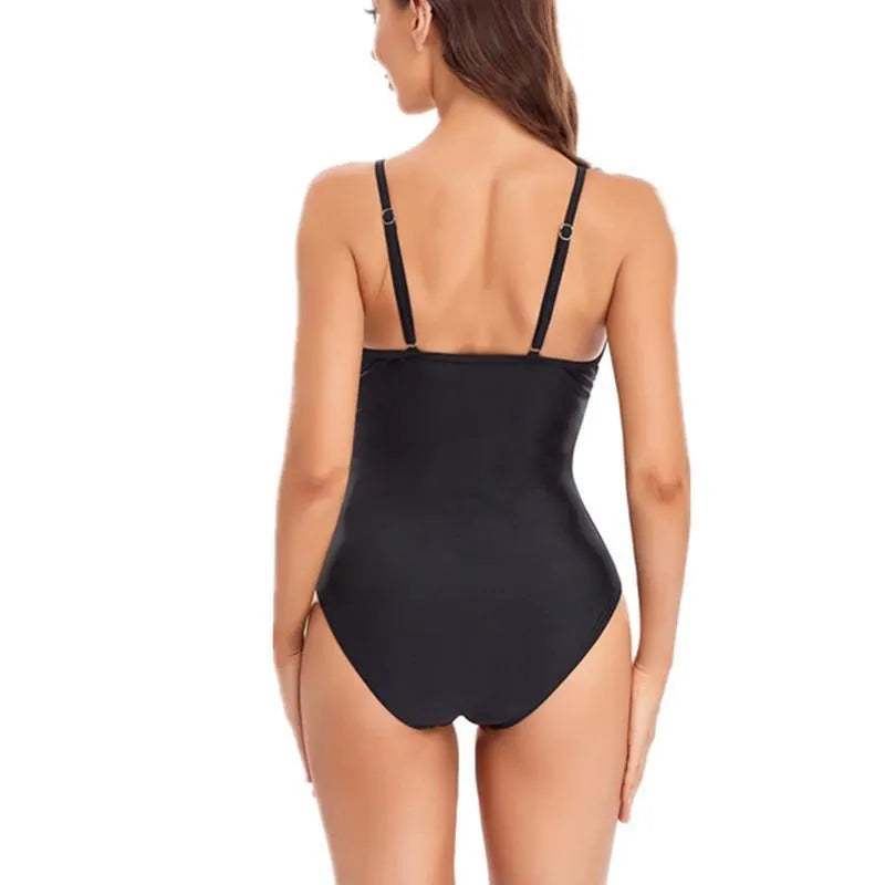 Ladies solid colour one-piece swimsuit with backless mesh design in black or blue.
