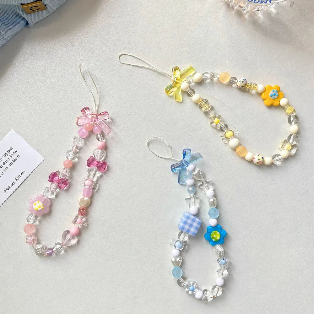 Beaded flower mobile phone lanyard in blue, pink, and yellow colour options