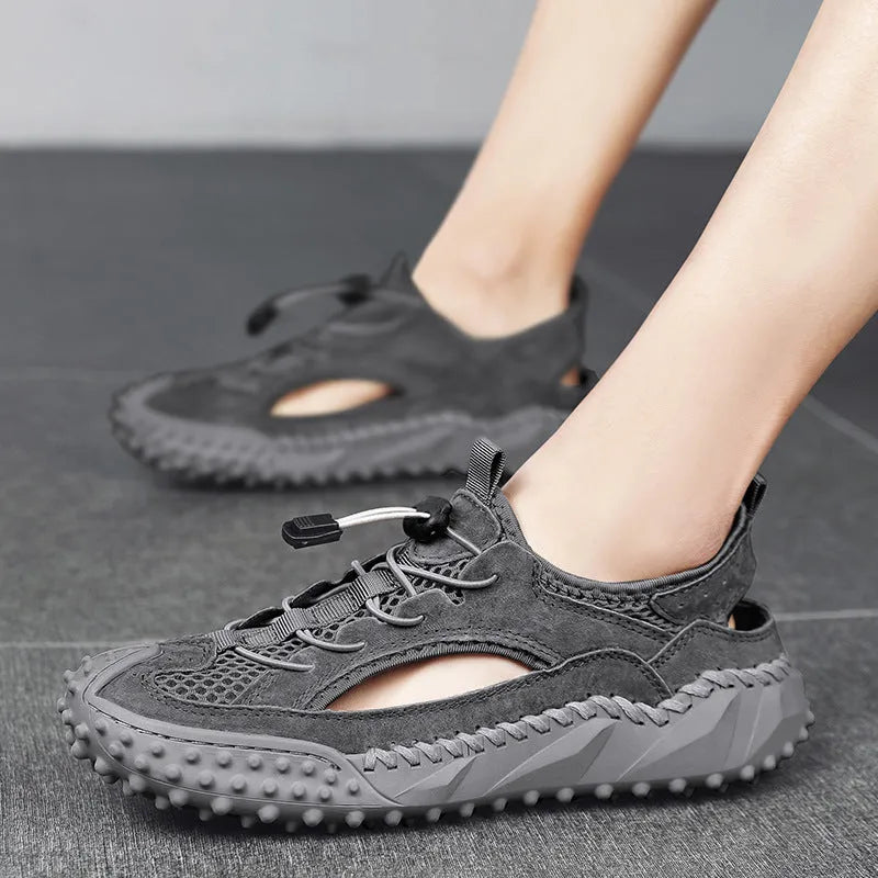 Men's black sports sandal with leather mesh upper, elastic band, and textured rubber sole.