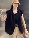 Women's loose fit polyester vest in milky white and black colours with pocket details.