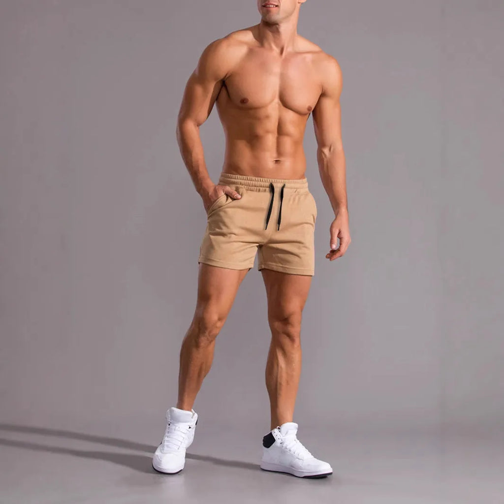 Three pairs of men's solid colour shorts in black, khaki and light brown with drawstring waists