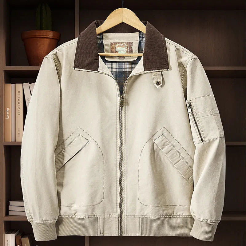 Men's washed cotton baseball flight jacket in beige, shown on a hanger.