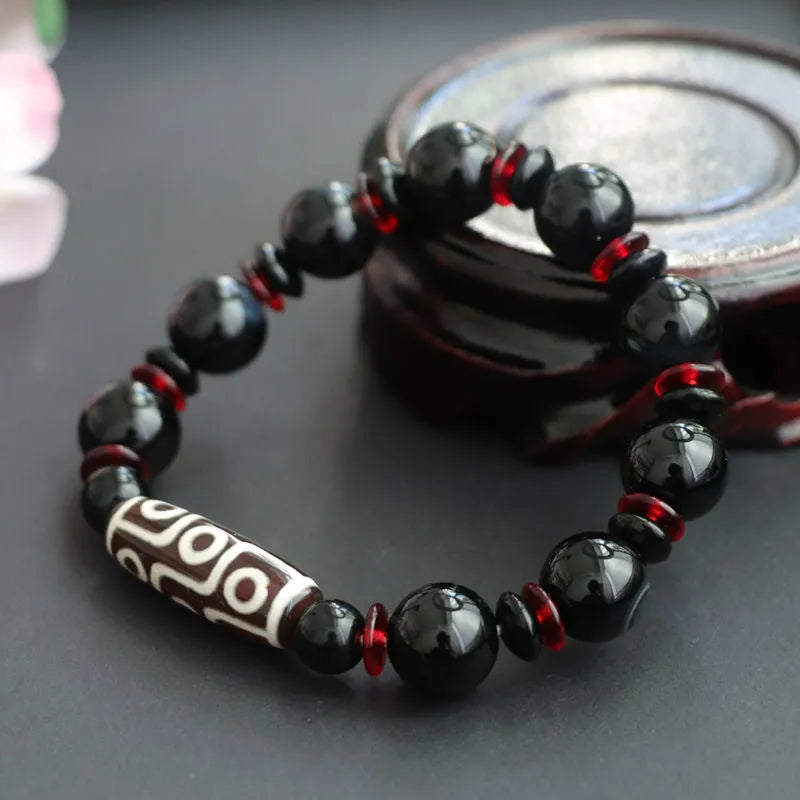 Hand-woven black agate dzi bead bracelet with geometry pattern on wrist