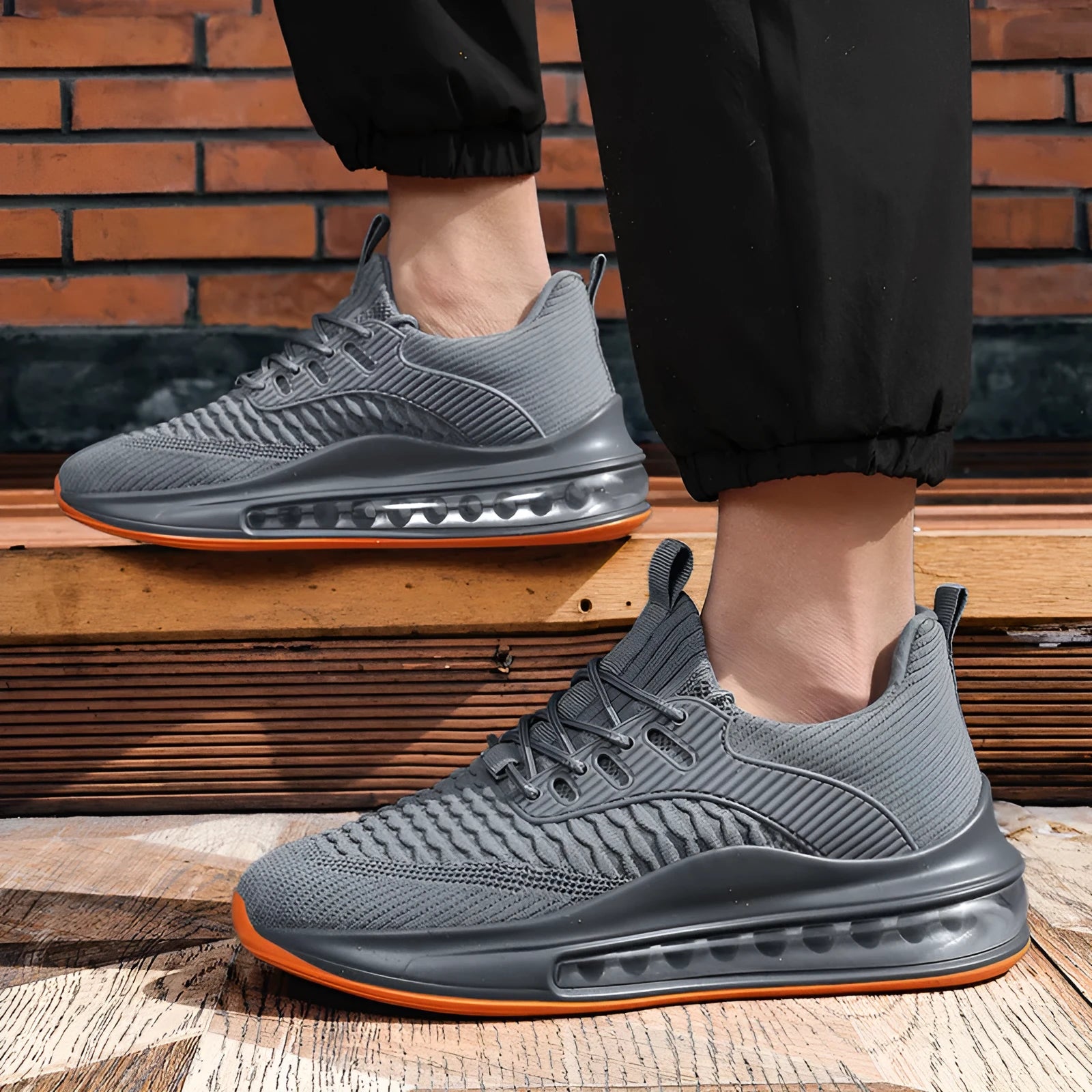 Men's low-top black mesh running sneakers with a round toe and lace-up front on a rubber sole.