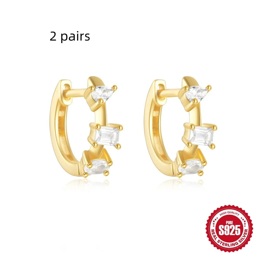 Sterling silver geometric stud earrings with small round diamond detailing in gold and silver electroplated finishes