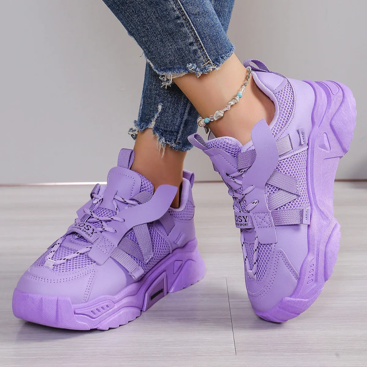 Women's purple platform mesh sports shoe with lace-up front and thick sole for height increase.