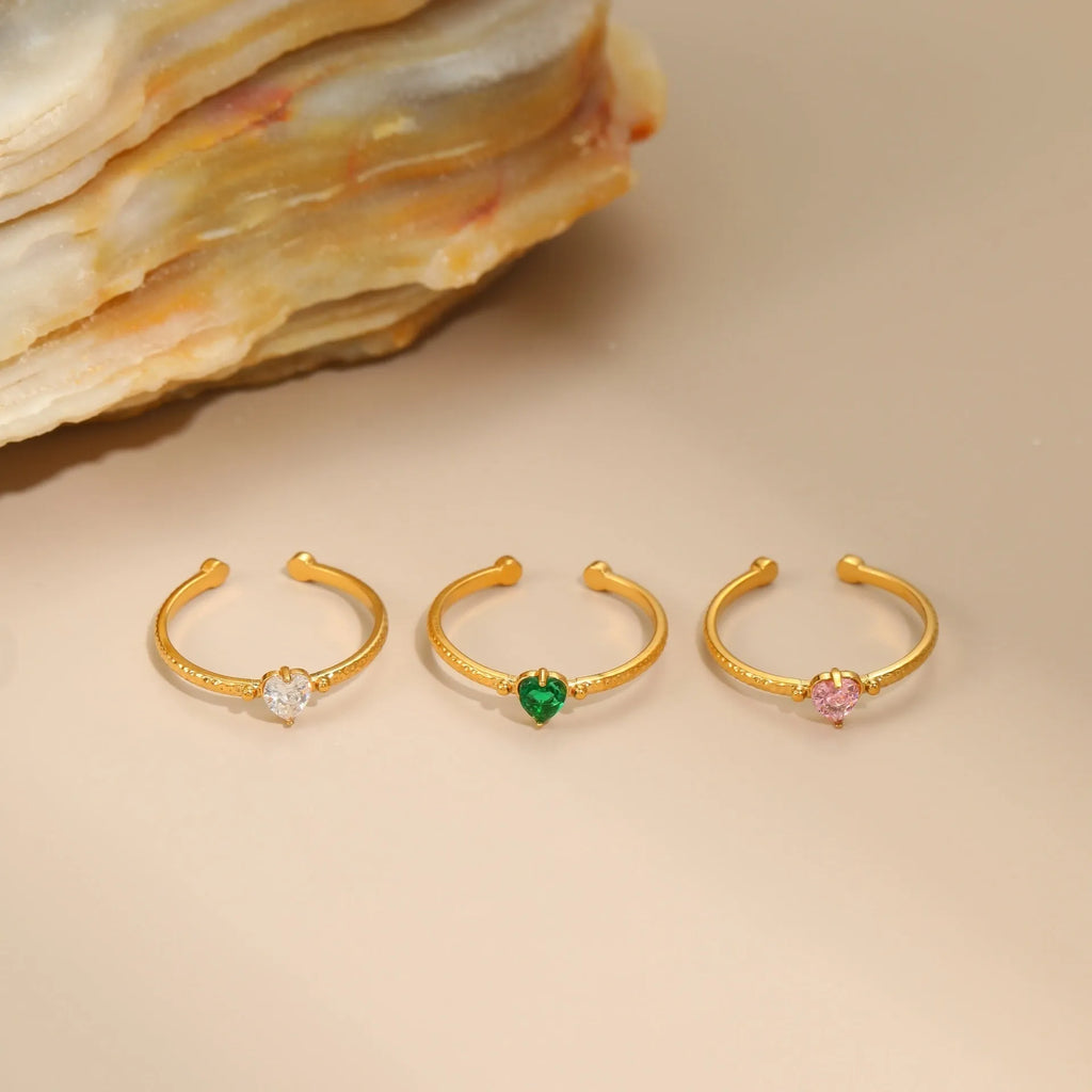 Open-ended stainless steel ring featuring a geometric heart shape with an inlaid zircon stone.