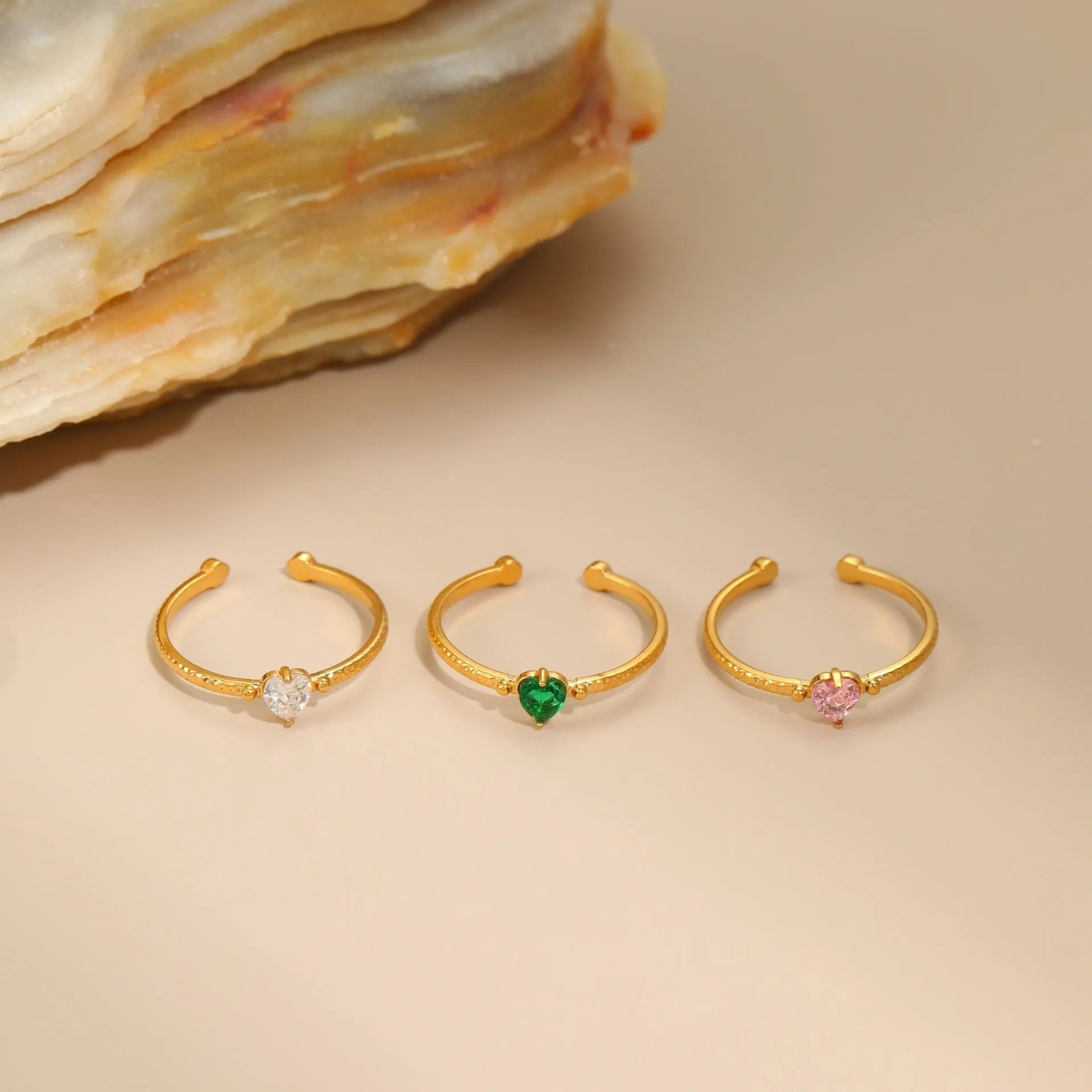 Open-ended stainless steel ring featuring a geometric heart shape with an inlaid zircon stone.