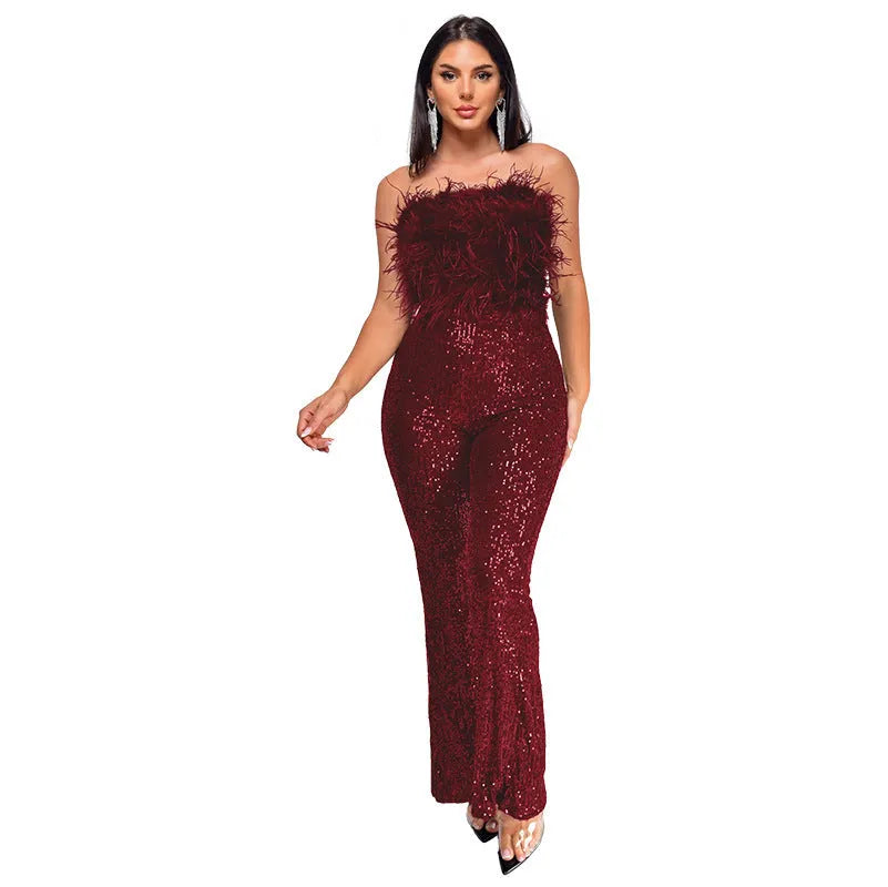 Woman wearing a black sleeveless backless jumpsuit with sequined top and flared legs.