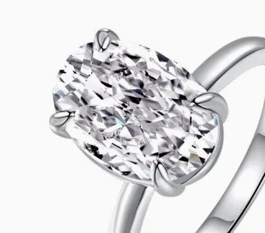 Oval women's ring with four-prong claw setting in gold or silver finish on a 9 silver band.