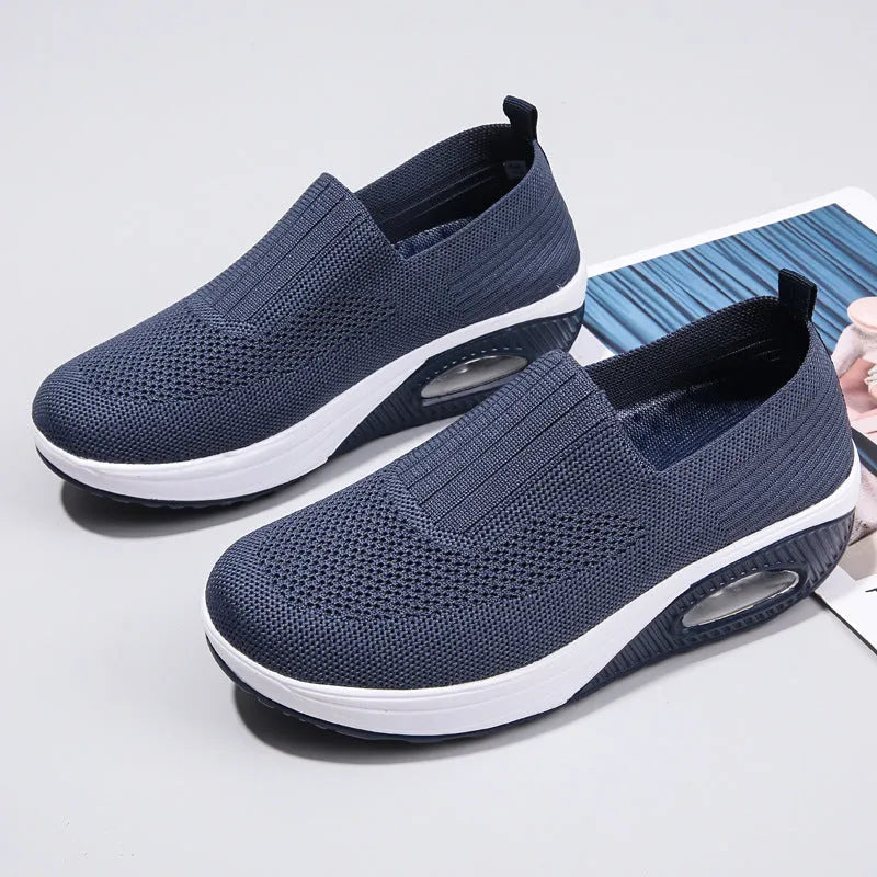 Women's casual running shoes with mesh and PU upper in light gray, showing round toe and mid heel.