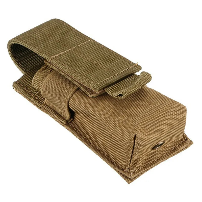 Black tactical MOLLE waist bag with elastic cord buckle, shown next to a small flashlight