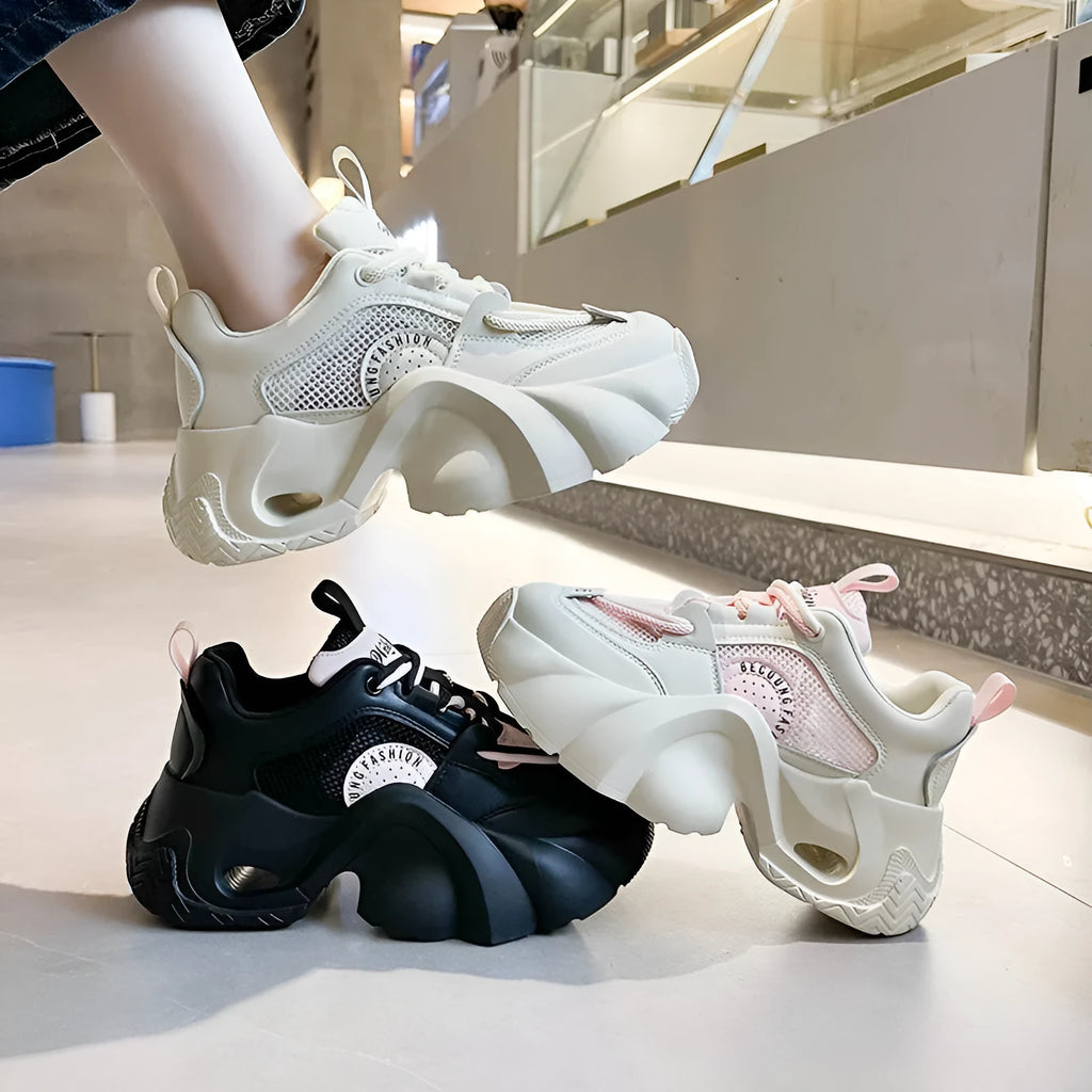 Women's casual sneakers in beige with thick sole, cross shoulder straps, and mesh lining.