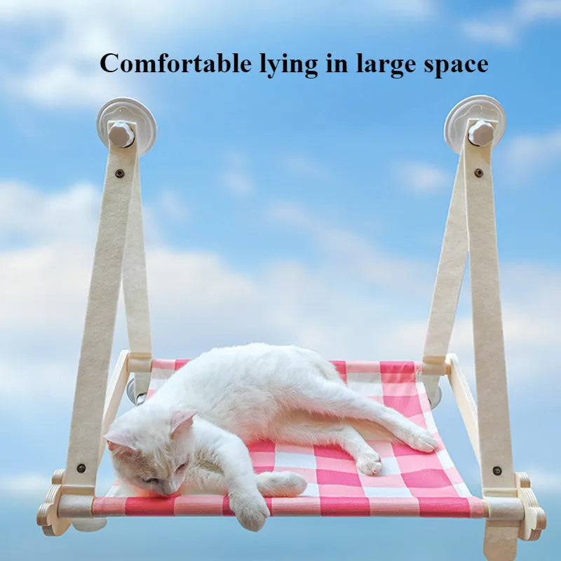 Wooden frame cat hammock with linen cushion mounted on a window, shown in green colour.