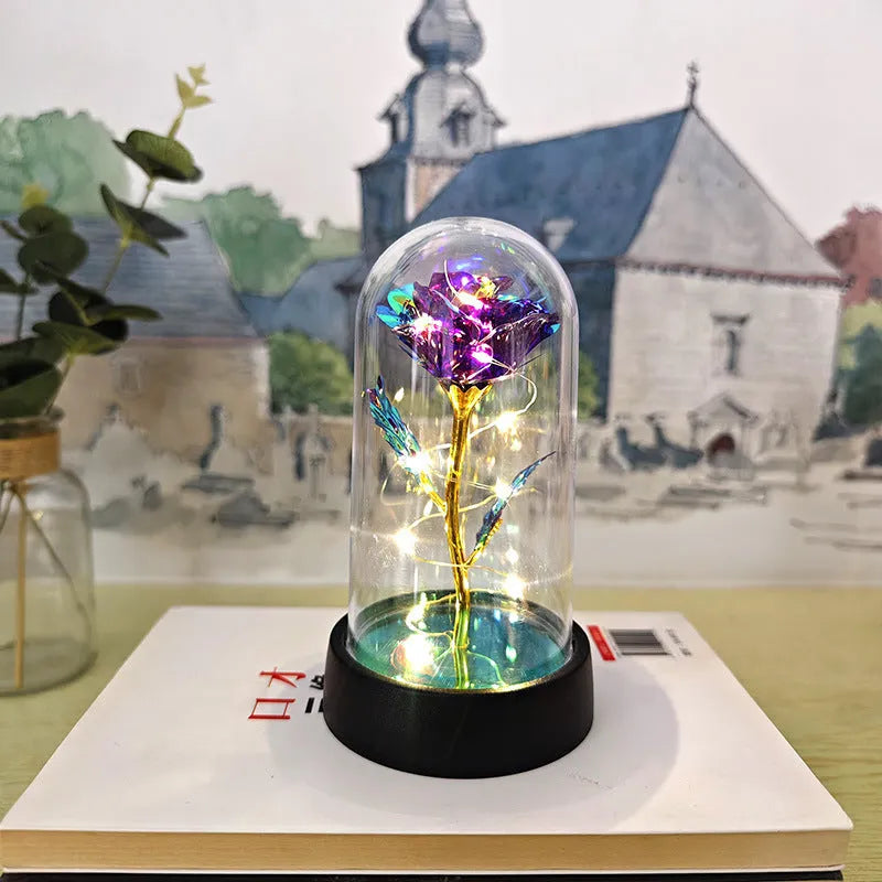 Small plastic night lamp with floral decoration and coloured light options on a black base.