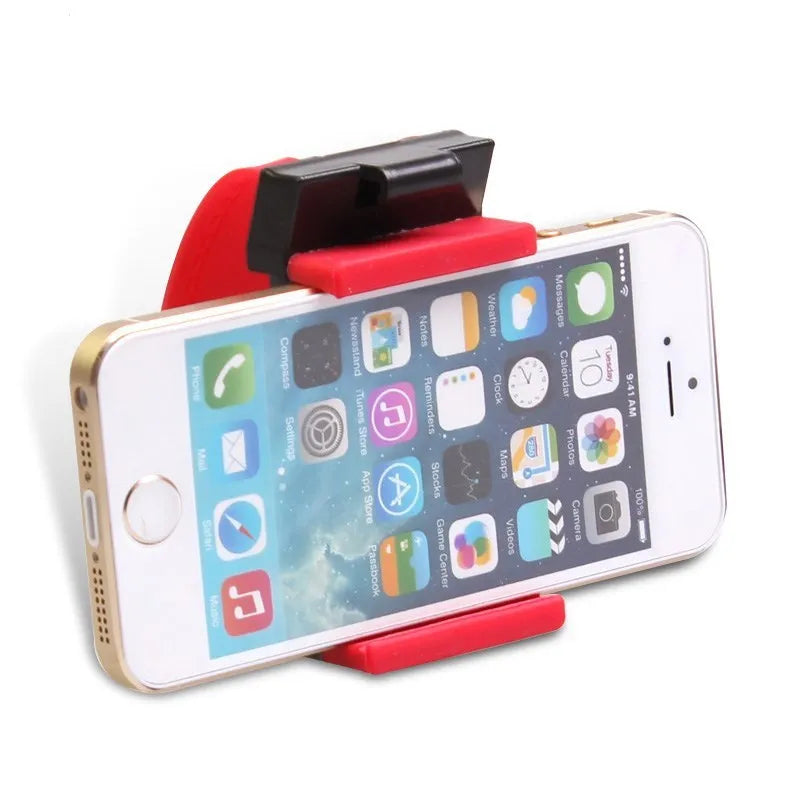 Black steering wheel phone holder clip mounted on car steering wheel holding a smartphone
