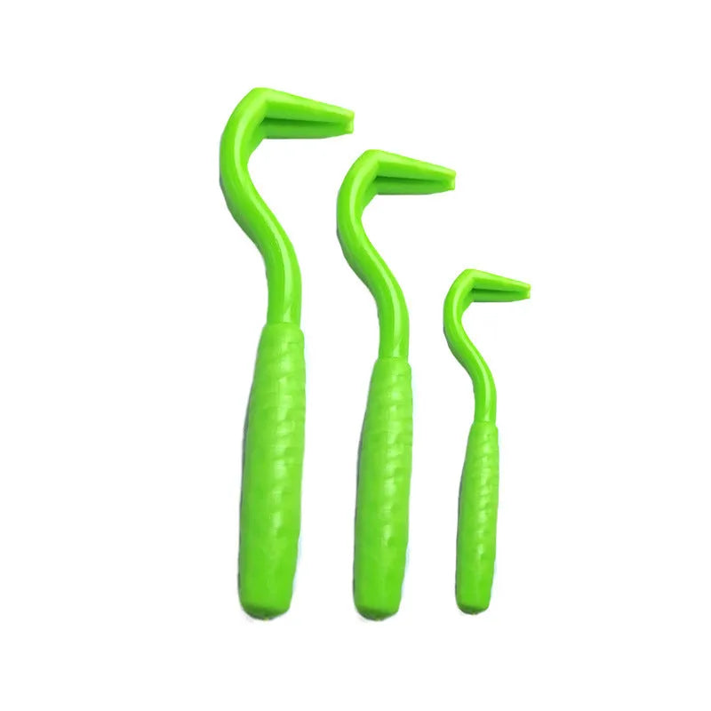Set of three coloured plastic tick hook removers for dogs on a white background.