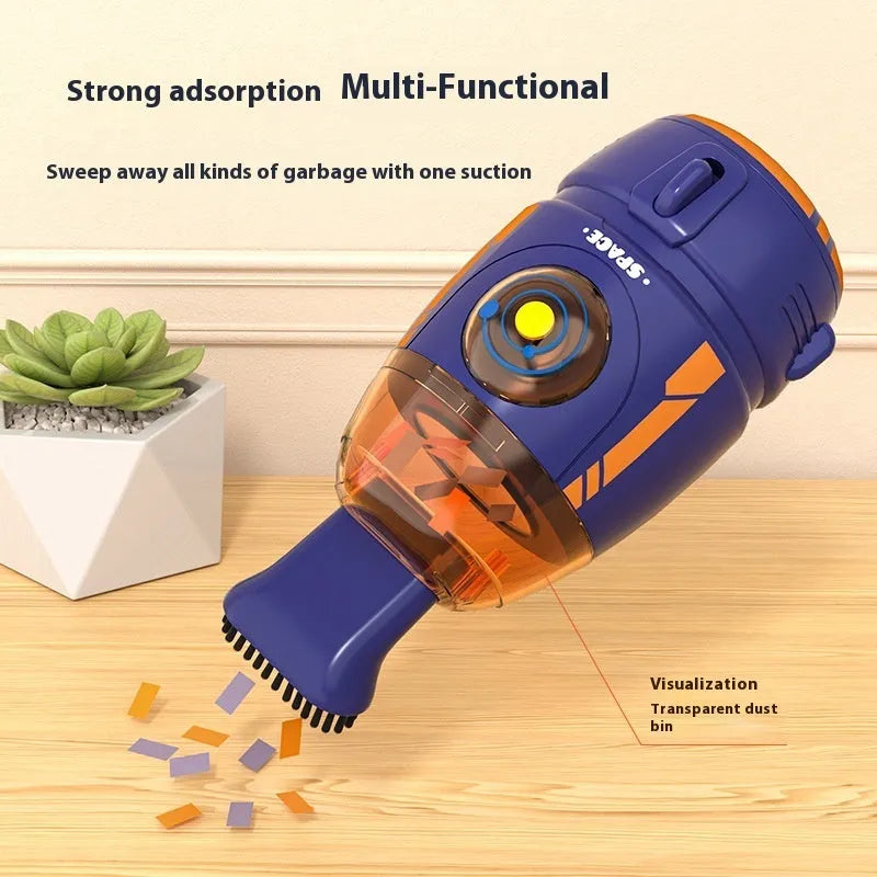 USB charging handheld desktop vacuum cleaner in blue rocket design on computer keyboard