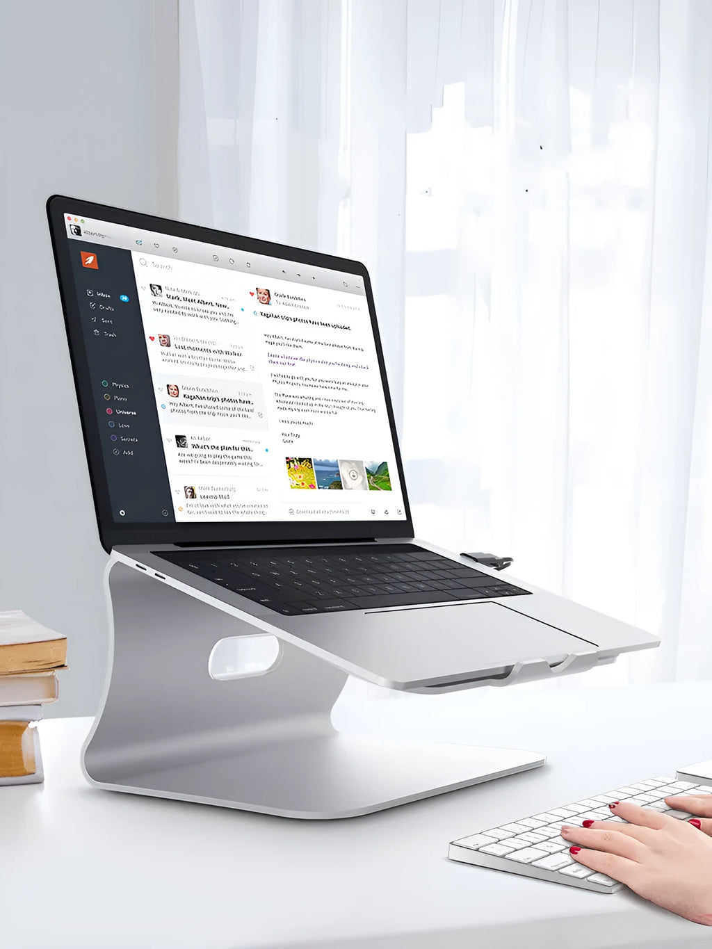 Aluminium laptop cooling bracket with rotating silver base on desk