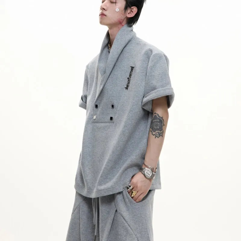 Men's dark grey cotton sports suit with metal embellishments, V-neck padded shoulders, short sleeves, and matching shorts