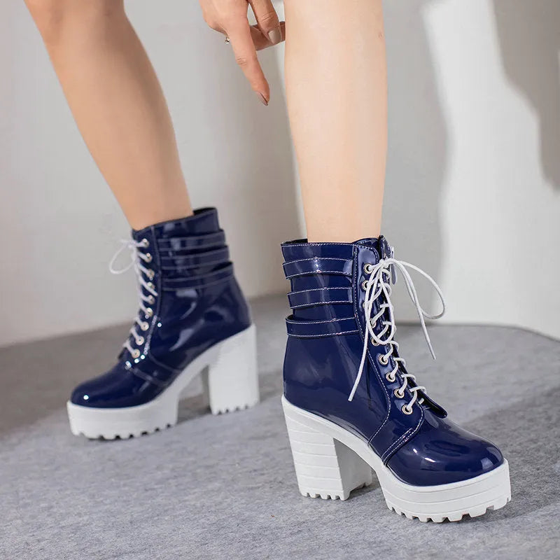 Women's black thick-heeled lace-up ankle boots with a round toe and rubber sole on a waterproof platform.