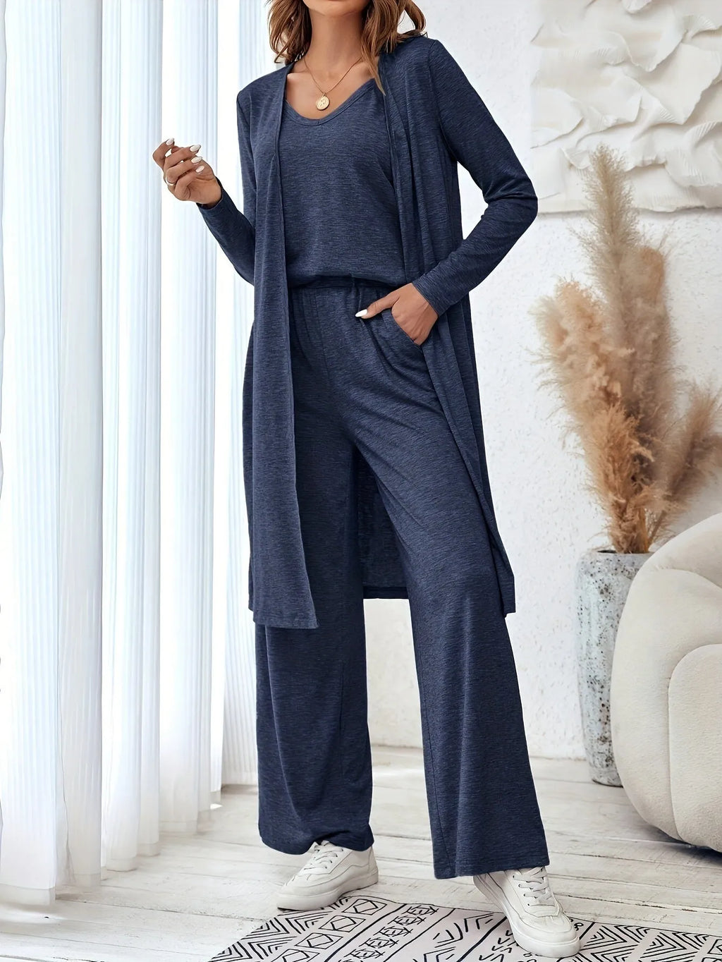 Blue three-piece women's suit set with long sleeve top and trousers in solid color