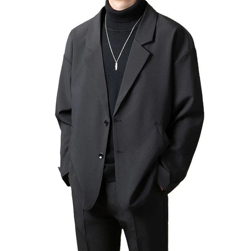Man wearing a loose fit casual suit jacket in a light business style, available in multiple colours.