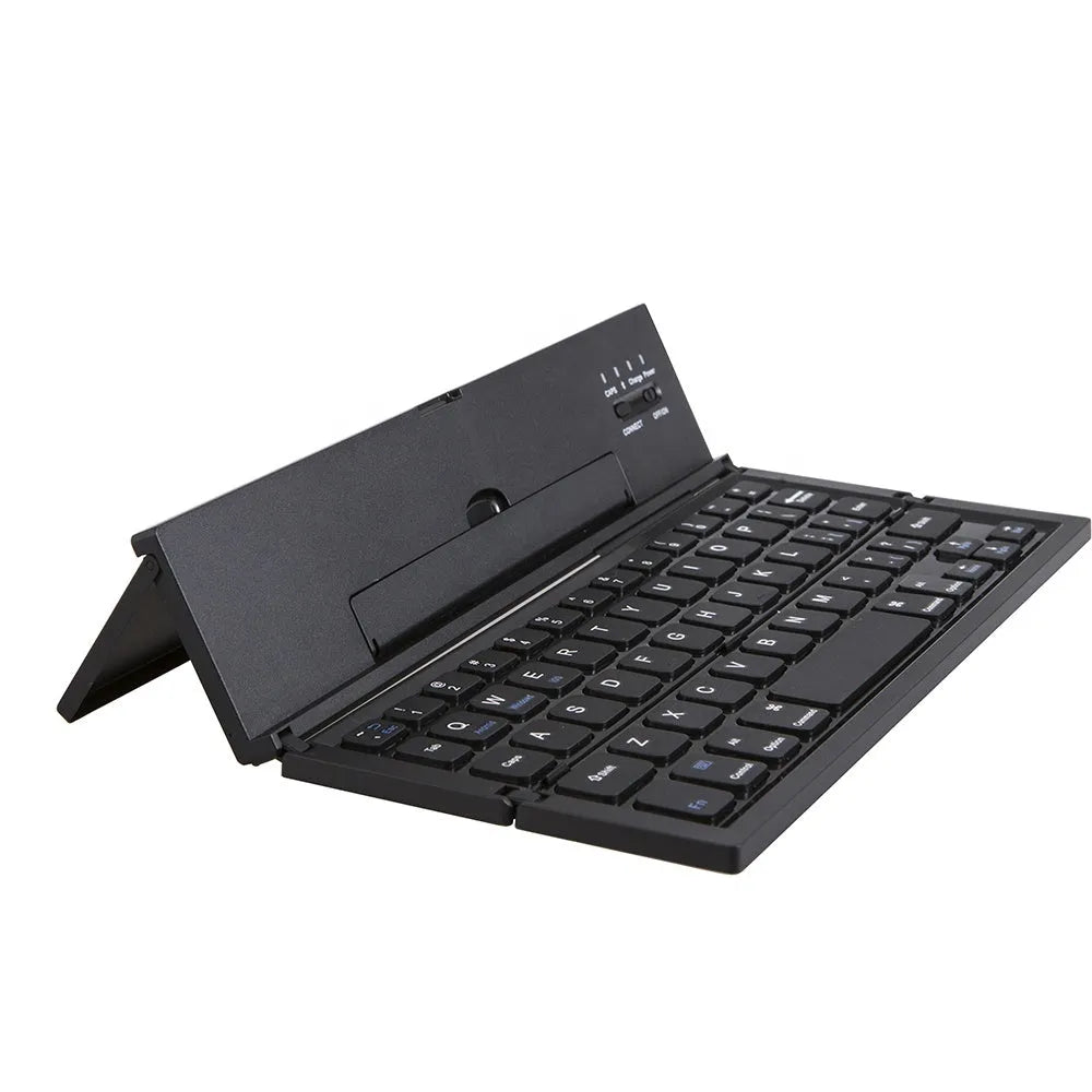 Black folding wireless Bluetooth keyboard unfolded next to tablet showing mini keyboard size