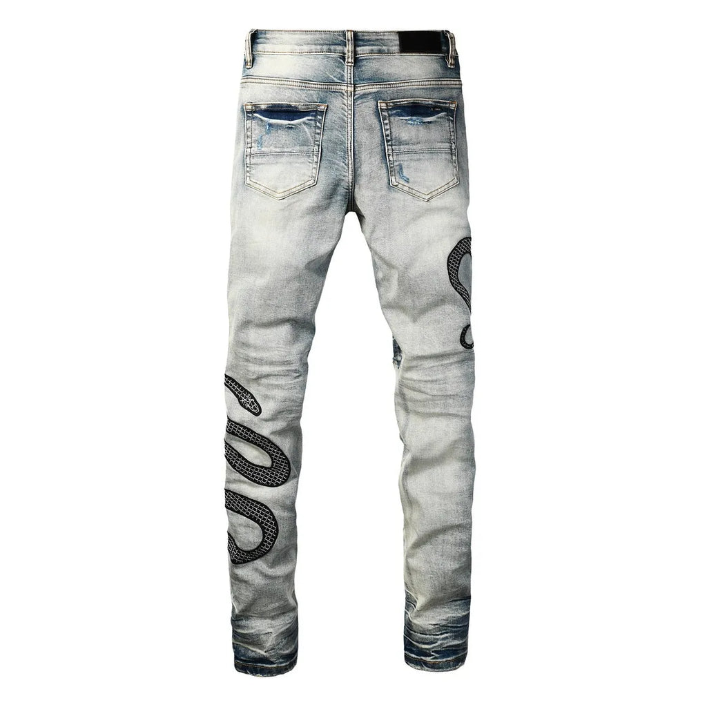 Blue distressed skinny jeans with a button fly on a mid waist, showing a slim fit and retro wash detail.