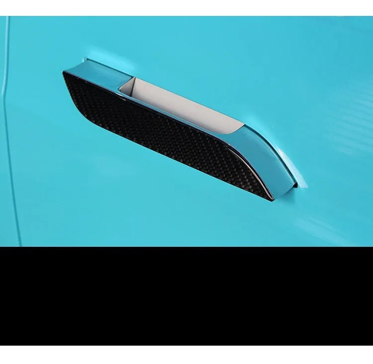 Four carbon fibre adhesive door handle protection stickers for Tesla Model S interior.