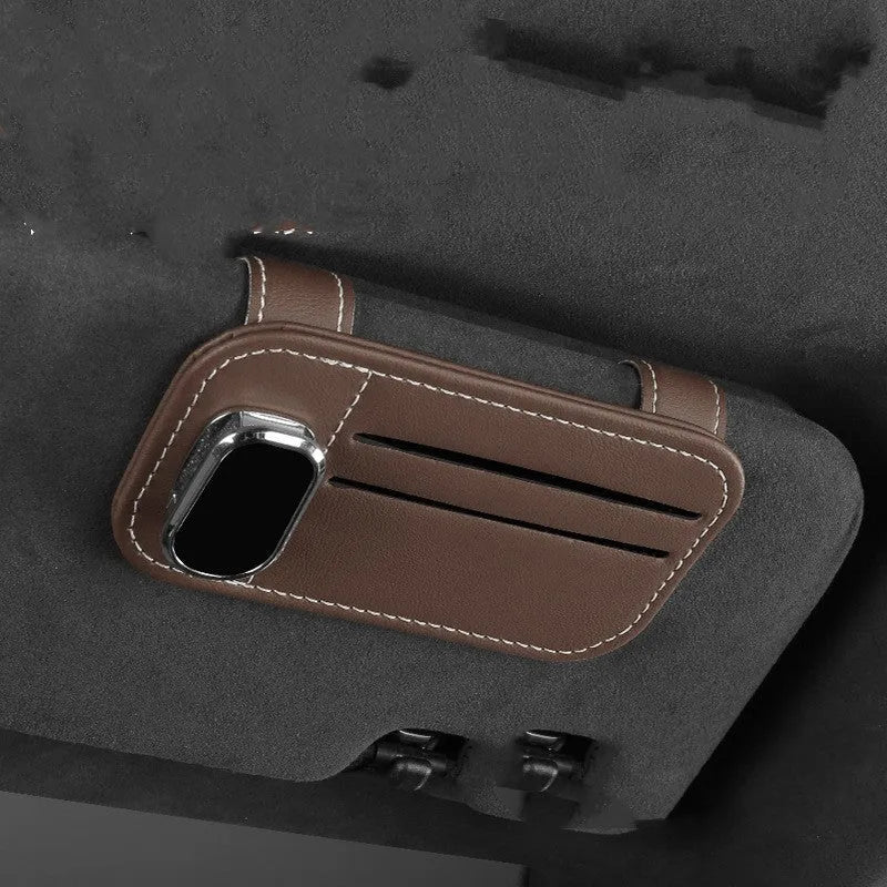 Beige leather car sun visor card holder with a glasses clip shown installed on a vehicle visor.