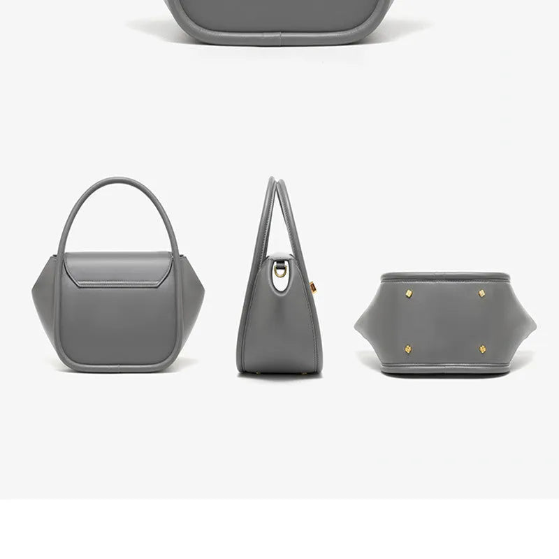 A soft cow leather wing-shaped tote handbag with a buckle and shoulder strap in black.