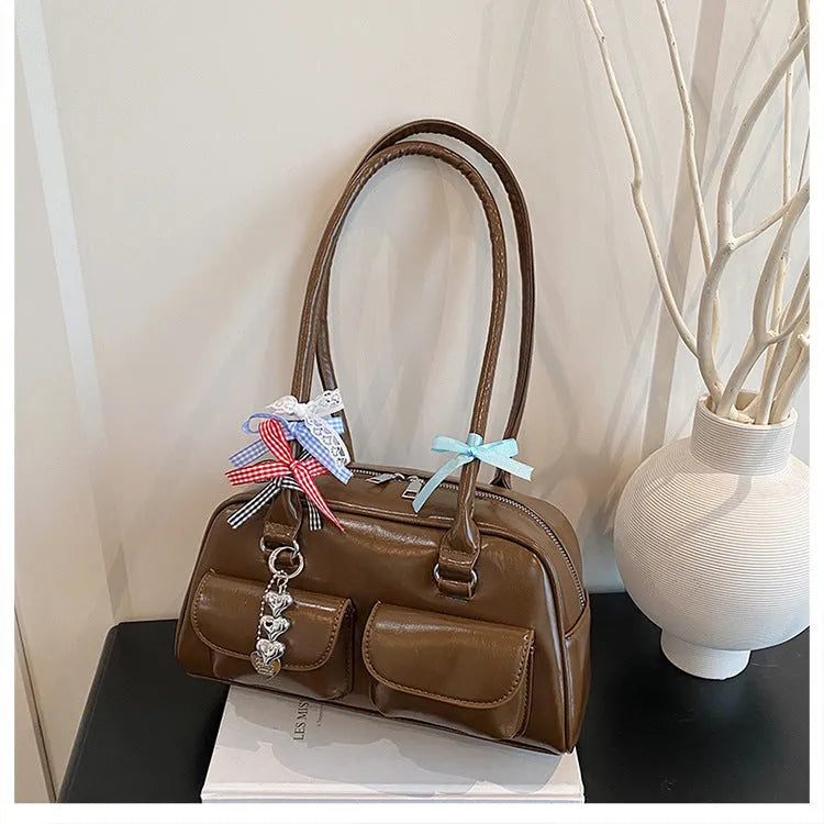 Retro brown PU leather women's shoulder bag with pillow-shaped design and double strap.