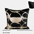 Black and gold abstract patterned flannel sofa cushion with removable cover on a grey sofa.