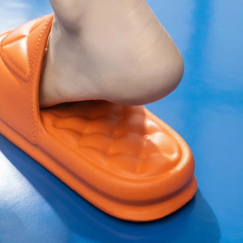 Soft EVA non-slip bathroom slippers with thick sole in assorted colours on a bathroom floor.
