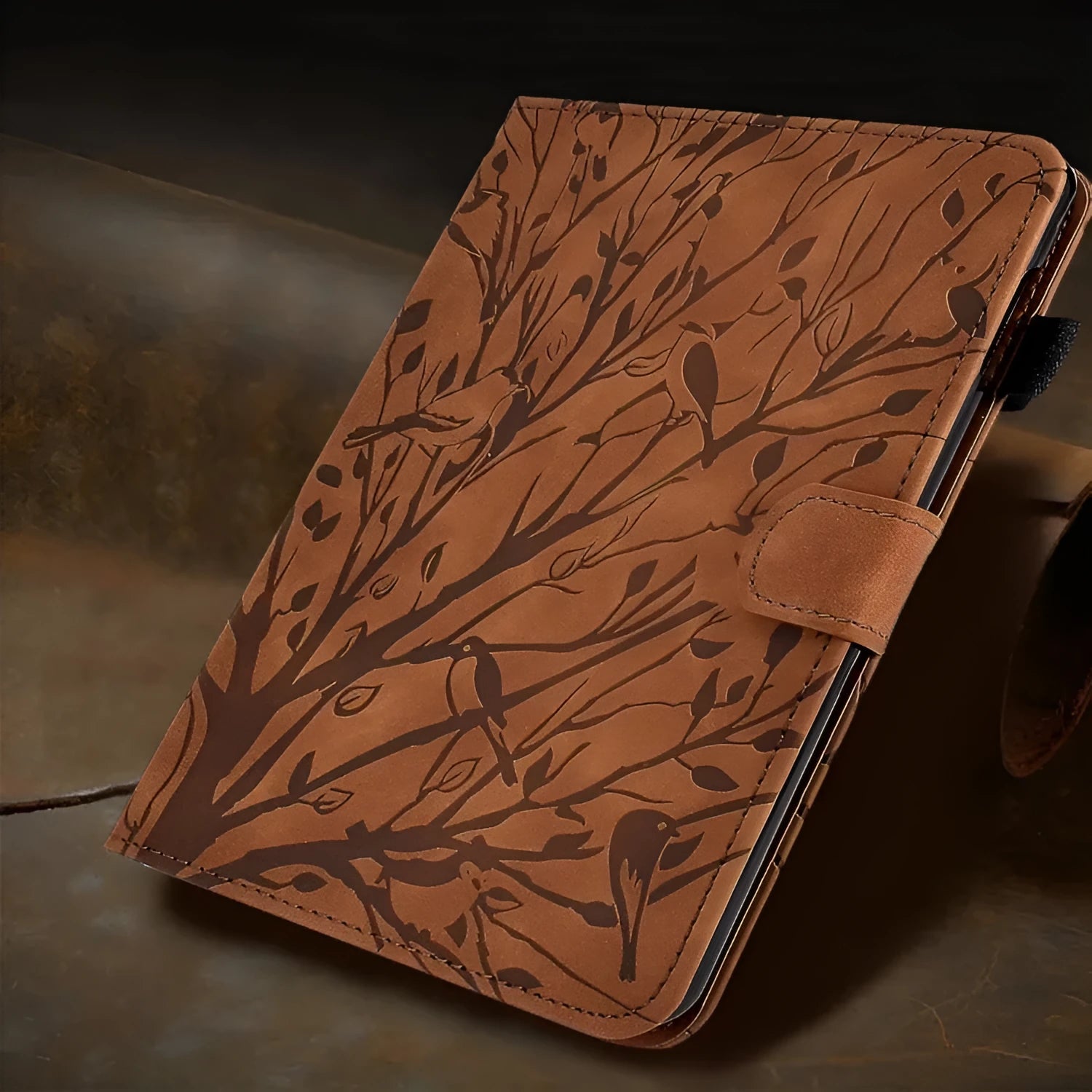 Black imitation leather tablet case with an integrated kickstand bracket, shown propping up a tablet.
