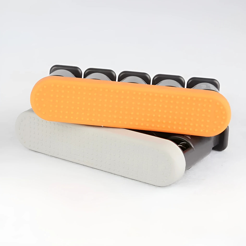 Grey and orange portable silicone finger trainer for musician hand muscle development.